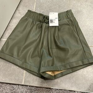 NWT leather shorts. green.